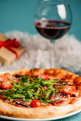 Christmas pizza on the wood board. Holiday celebration pizza. Italian cuisine concept.