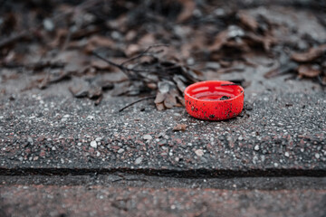 a drink lid as a drop on the road
