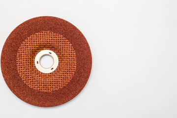 Abrasive wheel, grinding disc of orange, brown, isolated on white background. Abrasive materials, discs, tools close-up