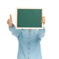 casual woman covering her face behind a green board