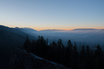 Sunset over the peaks of Western Tatras, Poland. Vivid colors of the sky, hazy panorama of the...