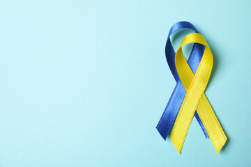 Down's syndrome awareness ribbons on blue background © Atlas