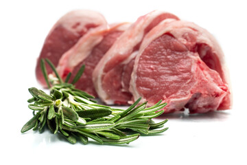 Fresh lamb loin chops on white background with green rosemary herb. Meat industry product