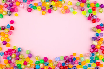 Combination of beads and beads on a pink background.