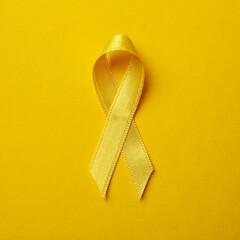 Childhood cancer awareness ribbon on yellow background