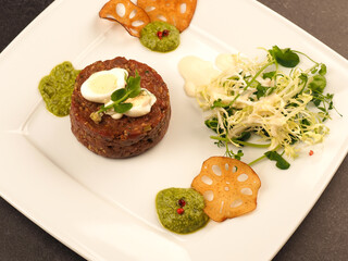 Beef tartare with a quail egg and fresh organic garden salad