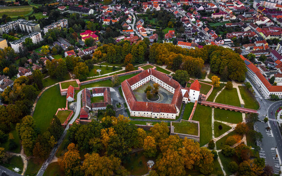 Sarvar, Hungary - Aerial panoramic view of the Castle of Sarvar (Nadasdy castle)  with golden coloured trees and foliage on a calm autumn morning