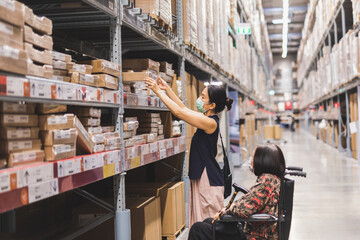 Woman in protective mask hand reaching box in Warehouse interior shelves.