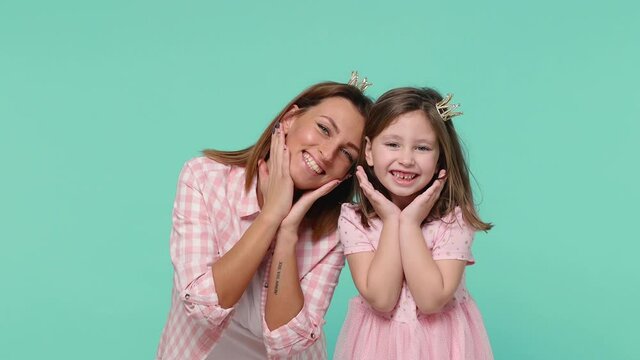 Happy woman in pink clothes crown corona have fun with cute child baby girl 5-6 years old. Mommy little princess kid daughter isolated on pastel blue background studio Mother's Day love family concept
