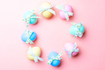 Easter frame. Colorful egg with tape ribbon on pastel pink background in Happy Easter decoration. Festive design in flat lay.