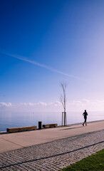 Fototapeta premium Middle aged man running in the waterfront