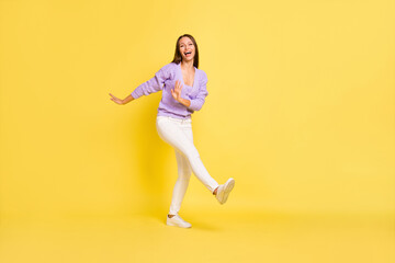 Fototapeta na wymiar Full length body size view of lovely carefree cheerful girl dancing having fun party isolated over bright yellow color background