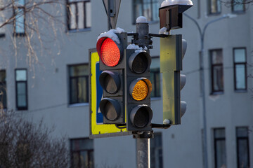 traffic lights with a red traffic signal on the street of the city