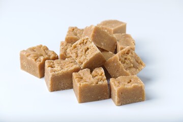 Homemade fudge cut into cubes on white backdrop