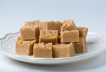 Homemade fudge cut into cbes on plate