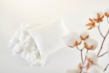 White pillow on the table and close up cotton flower decorative still life.