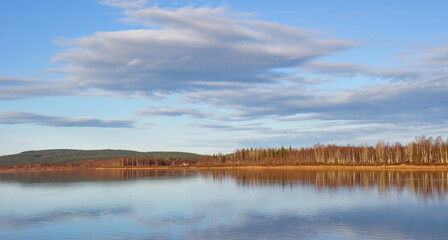 Fototapeta premium lanscape orange forest and clouds in sky and reflection in water, nature background, sunny day in autumn