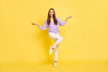Fototapeta na wymiar Full length body size view of attractive cheerful girl jumping posing having fun isolated over bright yellow color background