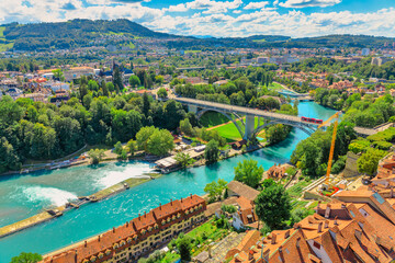 Obraz premium Aerial view of old town with medieval architecture and historical buildings in Bern, Switzerland from Cathedral bell tower. Federal Palace Swiss Parliament and Kirchenfeldbrucke bridge on background.