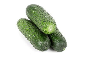 three green fresh cucumbers isolated on white background.