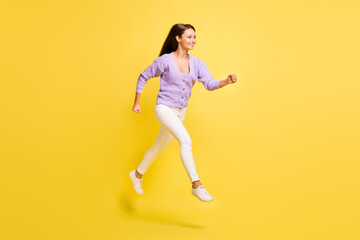 Fototapeta na wymiar Full length profile side photo of young excited girl happy positive smile jump go walk run sale isolated over yellow color background