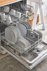 Dishwasher interior style close up with plate and glass.