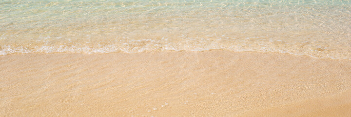 Fototapeta na wymiar sea with a gentle wave and a sandy beach. Travel, vacation concept. Banner.