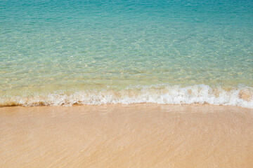Fototapeta na wymiar Sea with soft waves and sandy beach. Travel, vacation concept.