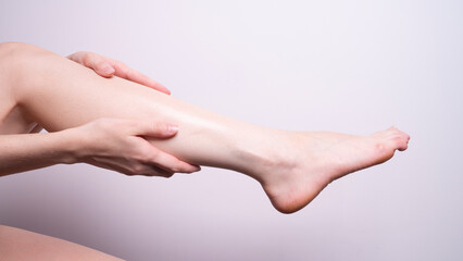 massage of leg muscles with hands, leg pain