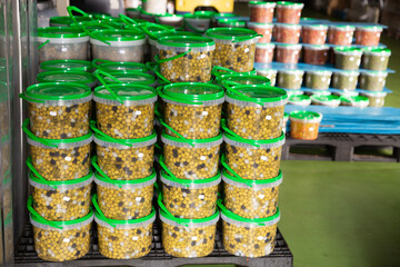 Pickled olives in plastic containers at store warehouse. High quality photo