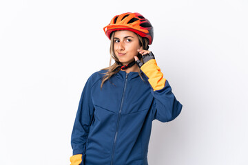 Young hispanic cyclist woman isolated on white background having doubts