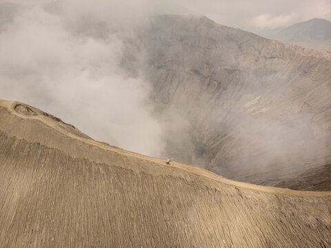 Aerial view of Mount Bromo crater releasing smoke from magma, an active volcano in East Java, Indonesia.