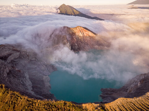 Aerial view of Ijen mountain range with its crater Kawah Ljen, known for its blue flames during a cloudy day, East Java, Indonesia.