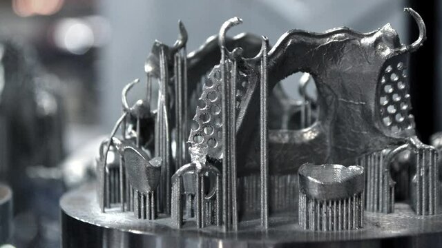3D model of human teeth printed on metal 3d printer close-up. Technology selective laser melting, sintering metal. New prototyping additive technology. Medical stomatological dental crowns bridge