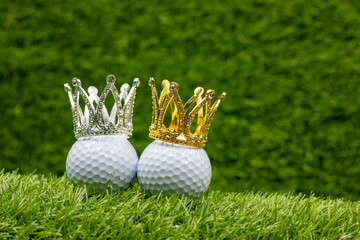 Golf ball with crown on green grass background