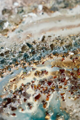 beautiful blotches of stones on delicate colors washed out by waves with gold accents. abstract background