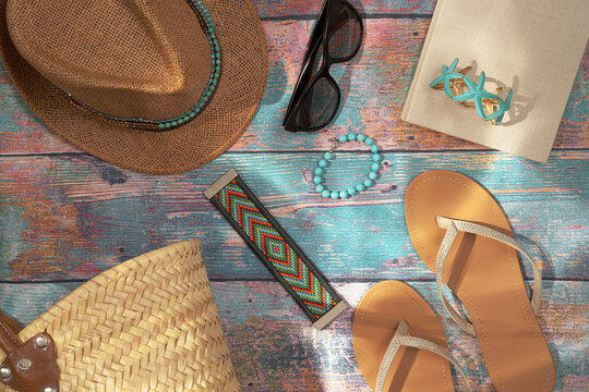 straw hat and shoes on colorful wooden background