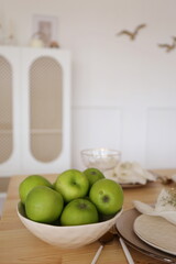 a plate with green apples on the slot