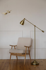 armchair and floor lamp on wall background