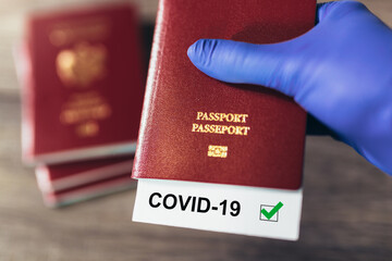 Travel and coronavirus concept, a note COVID-19 in tourist passport. Travel concept during the Covid-19 pandemic.