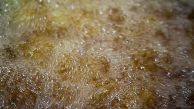 Closeup boiling oil fried food. Cooking frying in hot pot with Palm oil.