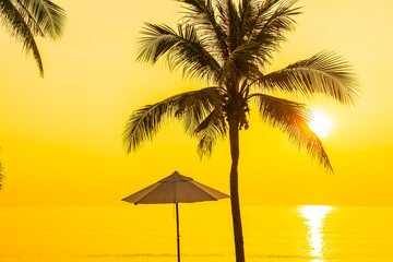 Umbrella and deck chair around beach sea ocean with coconut palm tree