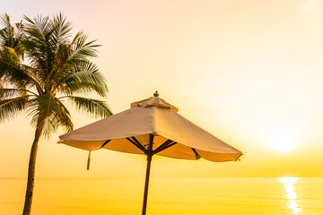 Fototapeta na wymiar Umbrella and deck chair around beach sea ocean with coconut palm tree