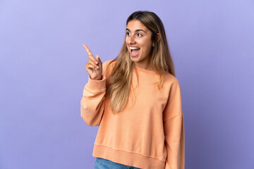 Young hispanic woman over isolated purple background intending to realizes the solution while lifting a finger up