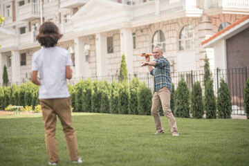 Dad and son playing together on a lawn