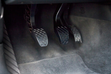Element of modern luxury car interior metal clutch brake and gas pedal. Manual gearbox controls of Sport car.