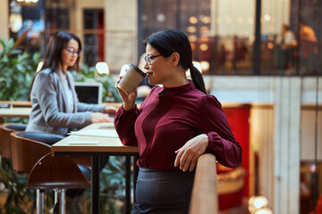 Young attractive brunette enjoying her aroma coffee