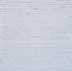 Brick wall painted with white paint.