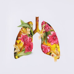 Human lungs made with fresh flowers and leaves on white background. Minimal coronavirus or pneumonia concept. Spring bloom, green, world health or environment day and ecology concept. Flat lay.