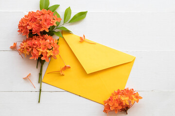 orange flowers spike flora of asia with yellow envelope arrangement flat lay postcard style on...